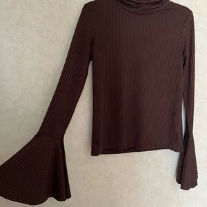 Brown turtleneck with flared long sleeves.